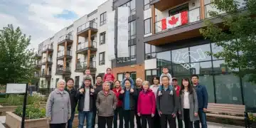 Diverse Canadians in front of affordable housing, symbolizing Canada Housing Benefit 2026 support.